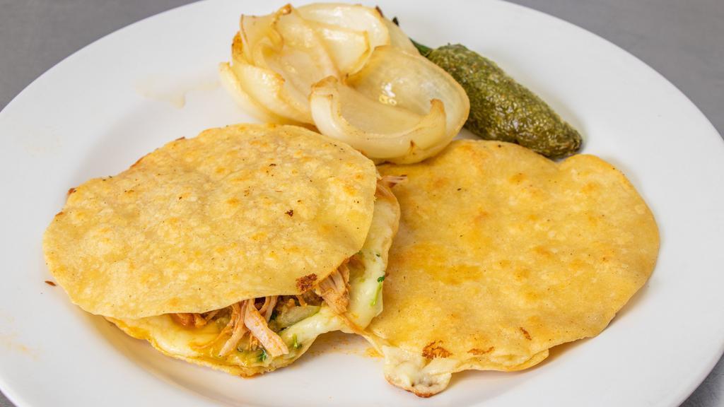  2-Multias · two corn tortillas filled with your meat choice and guacamole, onion, cilantro, and cheese.