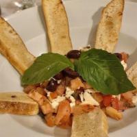 Bruschetta · Diced tomatoes, mozzarella, capers, basil, evo, served with garlic toasted bread