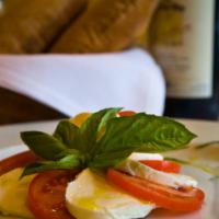 Caprese  · Fresh mozzarella, tomatoes, basil, olive oil.