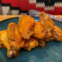 Crispy Wings · Tossed in House Dry Rub or Honey Habanero Wing Sauce, Served with Ranch or Bleu Cheese