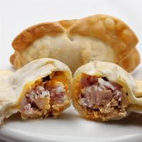 Pork Gyoza (5) · Our version of the traditional Japanese-style dumpling. It's freshly ground spiced pork mixe...