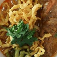 Khao Soi · Egg noodle, Crispy egg noodle, red onion, green onion, pickle mustard, cilantro and bean spr...