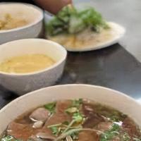 Meatball Pho · Beef meatballs in beef broth garnished with onion, scallion, cilantro, and a side of bean sp...