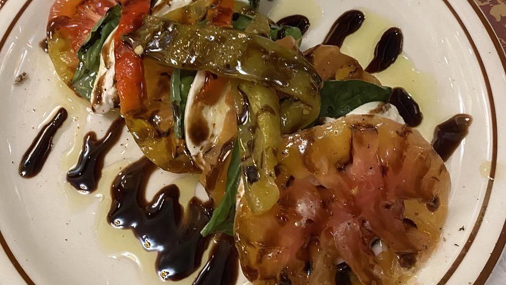 Caprese · Heirloom tomatoes, mozzarella di buffalo, and fresh basil finished with a balsamic drizzle (roasted peppers).