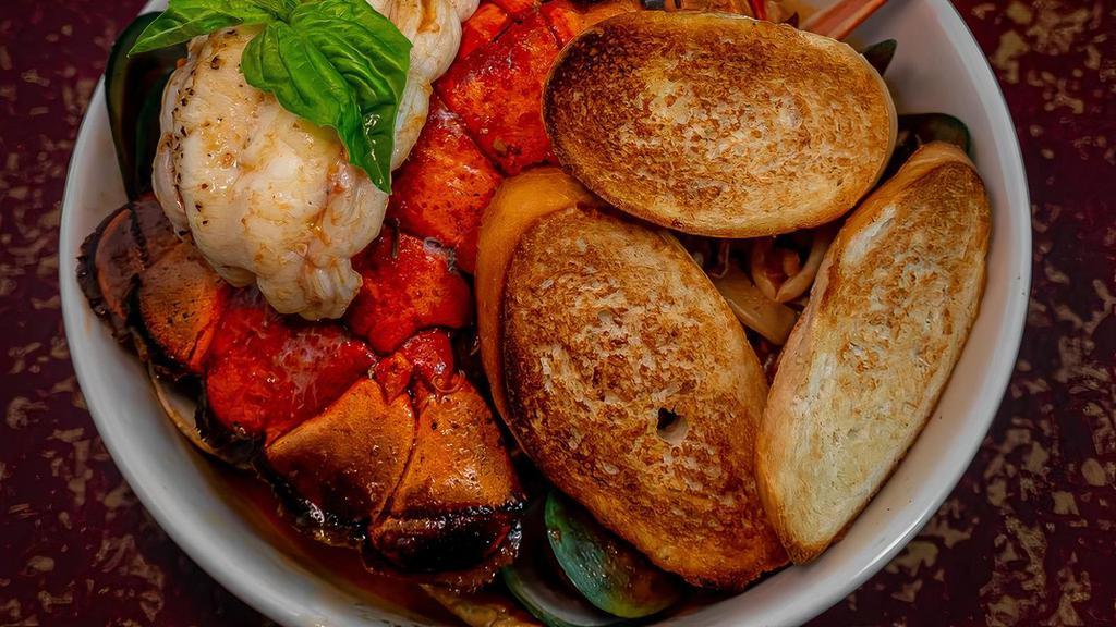 Marco Polo Sette Mare · Lobster, shrimp, scallops, clams, mussels, squid, and fish sautéed in garlic and white wine, and finished in a seafood both infused with tomato fennel, topped with chili flakes and herbed crostini.