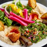 Vegetarian Combo · Hummus, baba ghanoush, grape leaves, tabouleh salad and 2 pieces of falafel, served with pit...