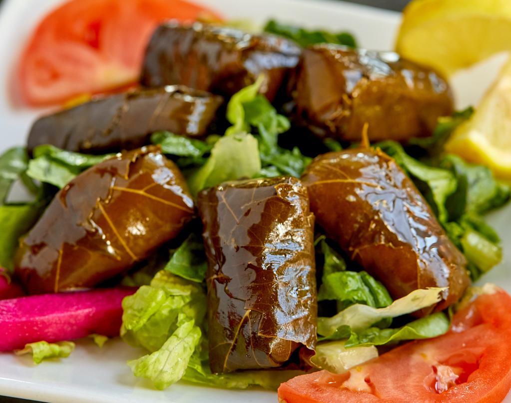 Dolma · Grape leaves stuffed with rice, tomatoes, parsley and lemon juice.