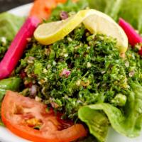Tabouleh · Finely chopped parsley, diced tomatoes, diced onions, dressed with lemon juice and olive oil.