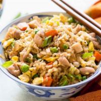 Chicken Fried Rice · Steamed rice stir fried with eggs peas carrots and green onions.