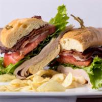 Turkey Club Sandwich · Roasted turkey breast, applewood smoked bacon, lettuce, tomato, onion, mayonnaise and hogie ...