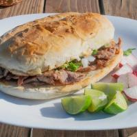 Al Pastor Torta · Homemade Mexican sandwich prepared with toasted Telera Bread grilled with butter, and topped...