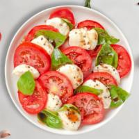 Caprese Salad · Fresh mozzarella, fresh basil, tomatoes, and virgin olive oil tossed with balsamic reduction.
