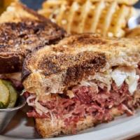 Reuben Sandwich · House-made corned beef brisket, sauerkraut, Swiss cheese, and Russian dressing on grilled ma...