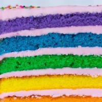 Rainbow Strawberry Cake Slice · Six layers of rainbow-colored vanilla cake filled high with a sweet strawberry buttercream i...