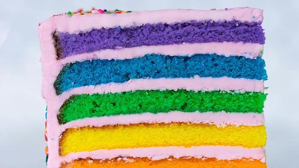 Rainbow Strawberry Cake Slice · Six layers of rainbow-colored vanilla cake filled high with a sweet strawberry buttercream icing.