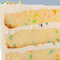 Vanilla Confetti Cake Slice · Vanilla cake with a burst of rainbow sprinkles filled and iced with a sweet vanilla buttercr...