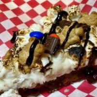 S'Mores Cookie Slice · Chocolate chip cookie base, topped with vanilla buttercream, toasted with marshmallows, tedd...