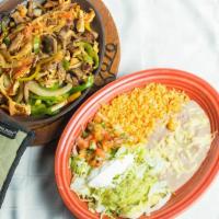 Fajitas · Tender sliced beef or chicken with peppers, onions and tomatoes. Served with rice, beans, gu...