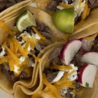 Tacos (4) · Served with onion, cilantro, radish, lime and homemade tomatillo sauce. 
Add rice and beans ...