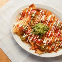 Meat Nachos · Crispy home made tortilla chips covered with melted cheese, jalapenos and tomatoes, your cho...