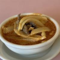 Massaman Curry · Massaman curry paste cooked with potatoes, yellow onion and peanuts in coconut milk.