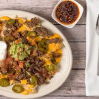 Nacho Meat Platter · Choice of meat, tortilla chips layered with meat, and nacho cheese, served with refried bean...