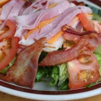 Chef Salad · Romaine lettuce, cheese, ham, cucumber, tomatoes, and onion mixed with 1000 Island dressing.