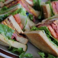 Club Sandwich · Toasted bread stuffed with ham, chicken breast, bacon, cheese, tomatoes and lettuce.