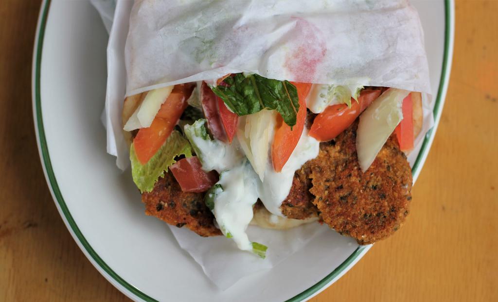Falafel Sandwich · Fresh homemade falafel grilled in olive oil served on pita bread with vegetables and our homemade tzatziki sauce.
