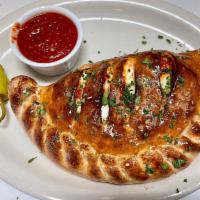 Modena Calzone · Pepperoni , Canadian bacon, mushrooms and black olives .. * Our Calzones come with Mozzarell...