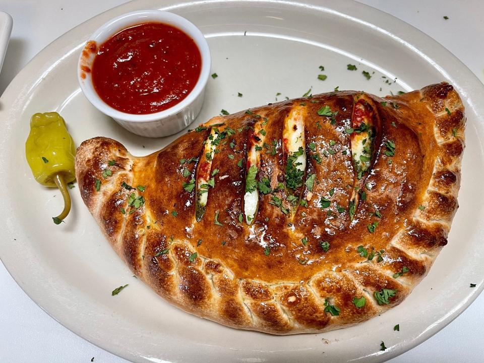 Modena Calzone · Pepperoni , Canadian bacon, mushrooms and black olives .. * Our Calzones come with Mozzarella, Ricotta and home made pizza sauce .