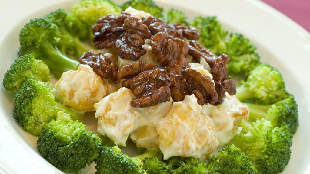 Honey Walnut Shrimp · Breaded Shrimp in creamy honey mayonnaise sauce, garnished with broccoli and topped with walnuts.