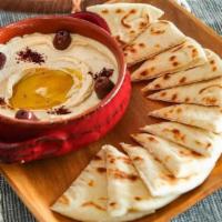 Hummus · homemade classic chickpea and tahini spread. Served with pita. This option is vegetarian, ve...