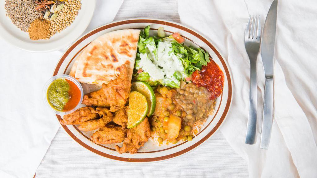 Curry Fried Fish Plate · Served with super basmati rice veggie curry house salad and a warm pita.