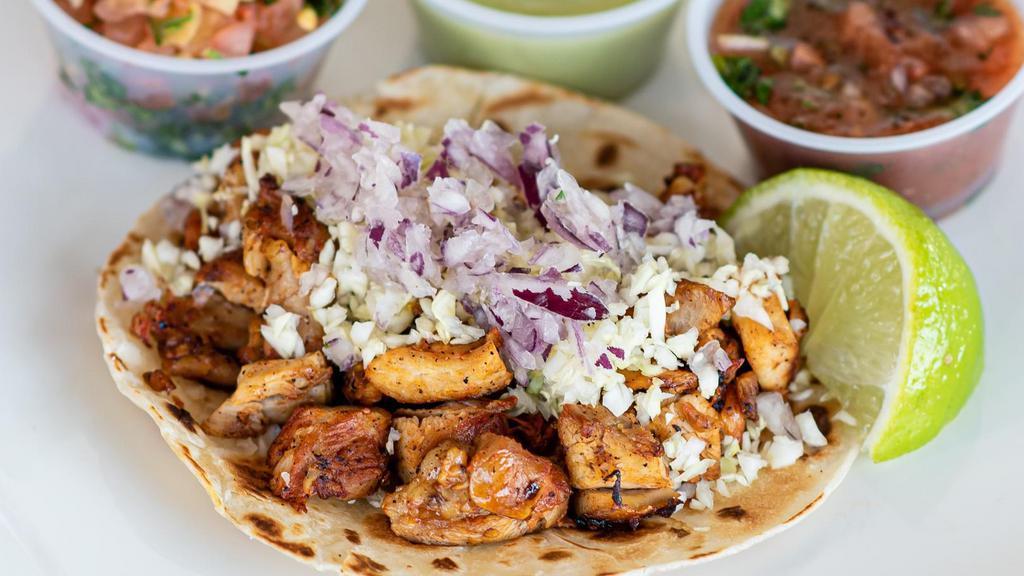 Chicken Taco · Pollo street taco marinated with citrus and anchiote seasoning. Topped with diced cabbage and red onion. Choice of corn or flour tortilla.