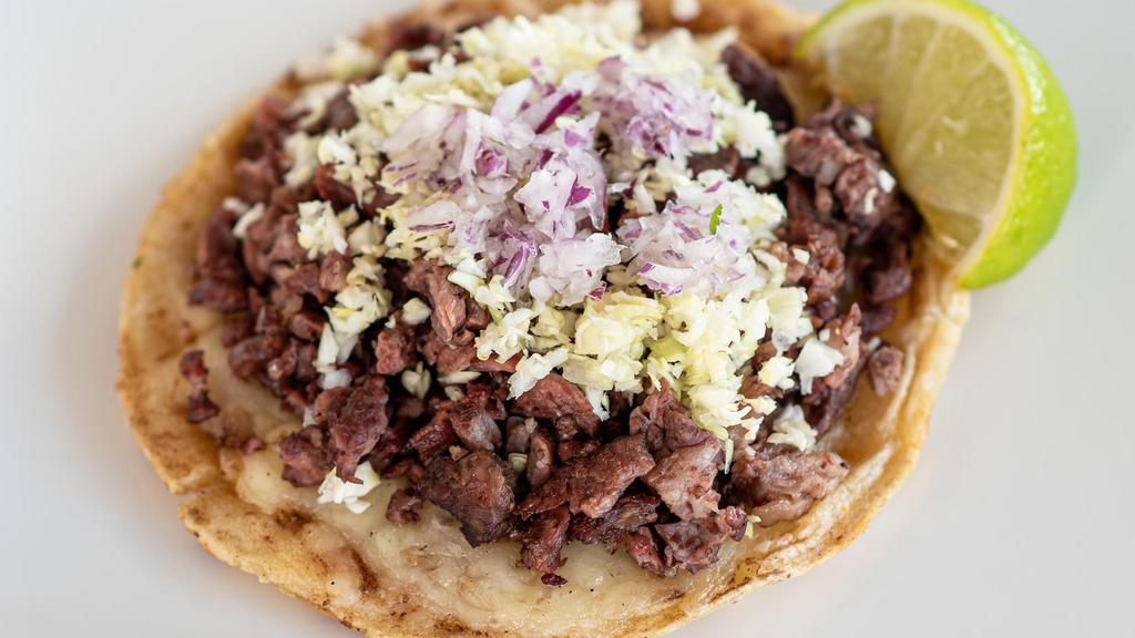 Steak Gordita · Handmade corn tortilla topped with Monterey Jack cheese, mesquite grilled carne asada, diced cabbage and diced red onion.