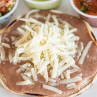 Bean And Cheese Tostada · Crisp corn tortilla topped with melted Monterey Jack cheese and refried beans.