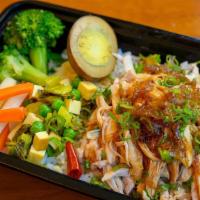 Taiwanese Chicken And Rice · Whole chicken thigh, braised and pulled apart, topped with garlic oil, a shallot-reduction s...