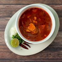 Menudo · Traditional soup made with beef honeycomb tripe, simmered in a beef broth and served with on...