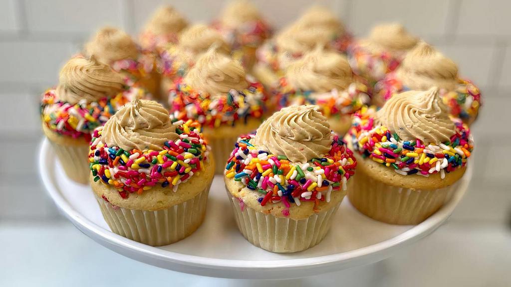 Funfetti Cupcake · Our scratch made vanilla confetti cake topped with delicious cookie butter buttercream and a plethora of rainbow sprinkles inside and out! 
CONTAINS: ALMOND EXTRACT