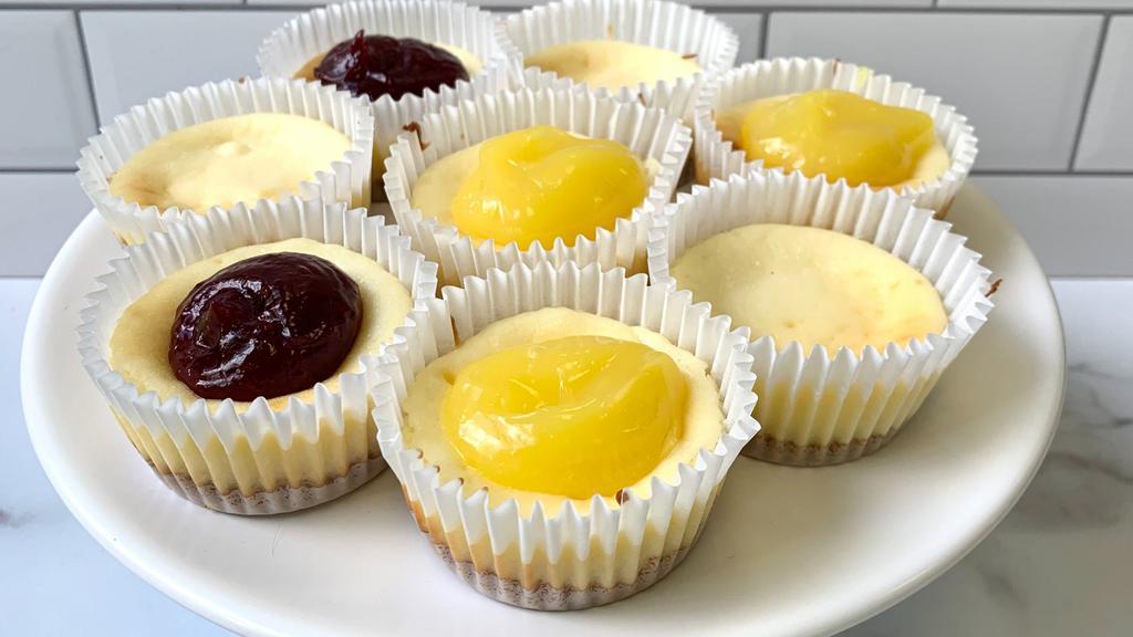 Assorted Mini Cheesecake (4) · A petite sweet, our mini cheesecakes are made in house and fit in the palm of your hand. Classic graham cracker crust with plain cheesecake filling with assorted topping flavors like raspberry, blueberry, lemon and plain. 
Approximately  3