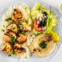 Shish Tawook · Grilled chicken served with rice, hummus, and salad.