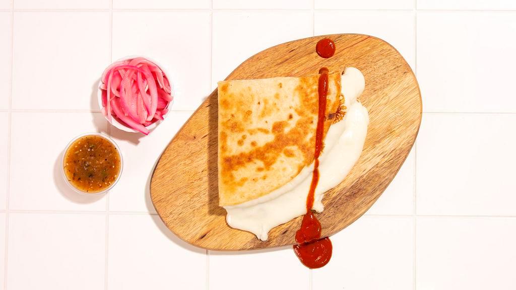 Quesadilla · Grilled corn tortilla filled with Oaxaca cheese.
