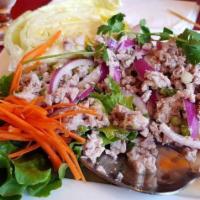 Larb · Eastern Thailand's famous salad with ground chicken mixed with onion, cilantro, lime juice, ...