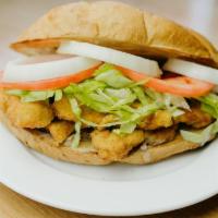 Torta De Milanesa · Breaded beef or chicken, with beans, lettuce, tomatoes, onions, guacamole, and mayonnaise, s...