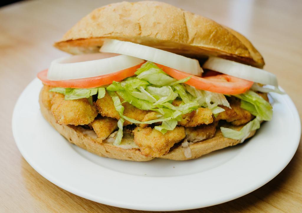 Torta De Milanesa · Breaded beef or chicken, with beans, lettuce, tomatoes, onions, guacamole, and mayonnaise, served on Mexican bread.