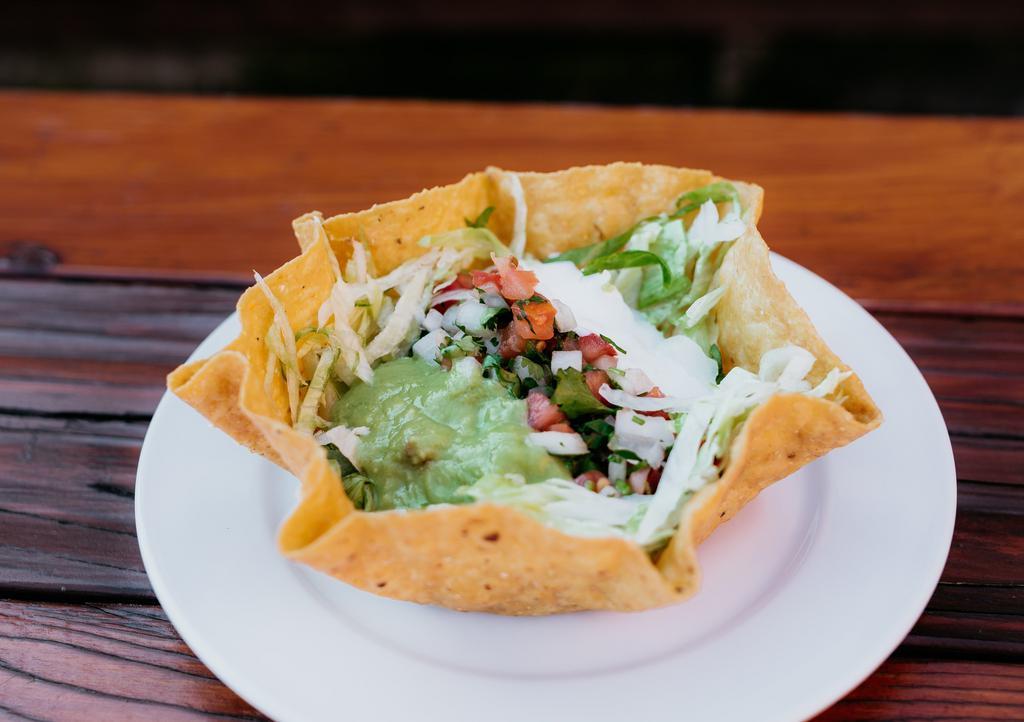 Taco Salad · Corn tortilla bowl that comes with a choice of meat, beans, lettuce, pico de gallo(onion, tomato, cilantro), cheese, sour cream, and guacamole sauce. Extra toppings for an additional charge.