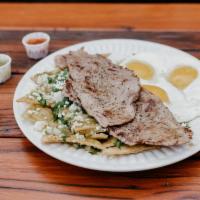 Chilaquiles With Eggs And Meat · Tortilla chips  in green salsa, with a choice of meat, topped with onions, cilantro and ques...