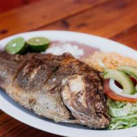 Mojarra Plate · Fried whole tilapia served with salad, beans, rice, and 4 corn tortillas.