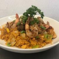 Surf & Turf Rice · Filet mignon and shrimp with garlic sauce atop yellow fried rice.